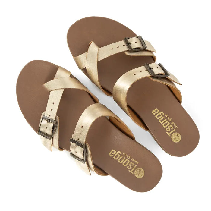 Pair of gold sandals with "Tsonga" branding on a white background