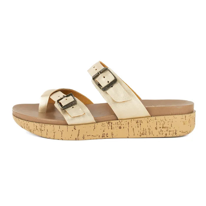 Gold sandal with cork print sole on a white background