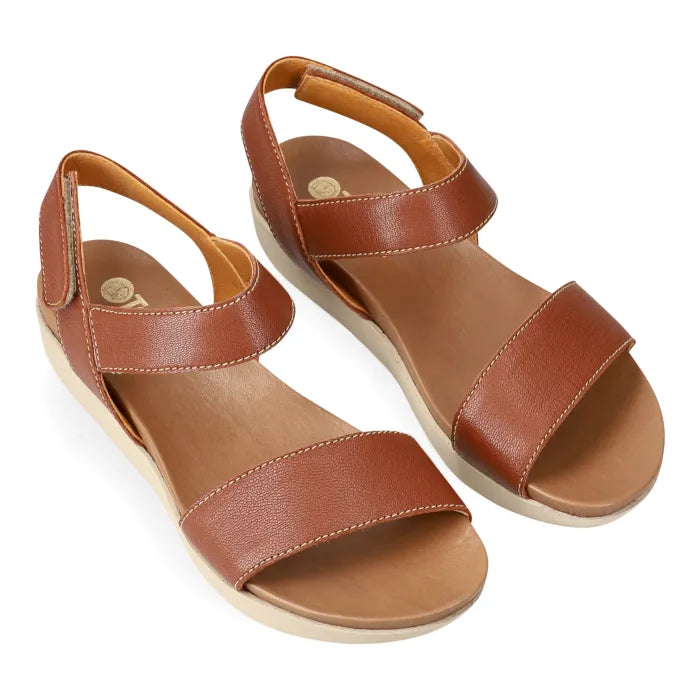 Brown sandal with multiple straps on a platform sole on a white background