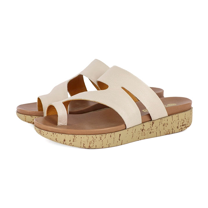 Pair of beige sandals with cork sole on a white background