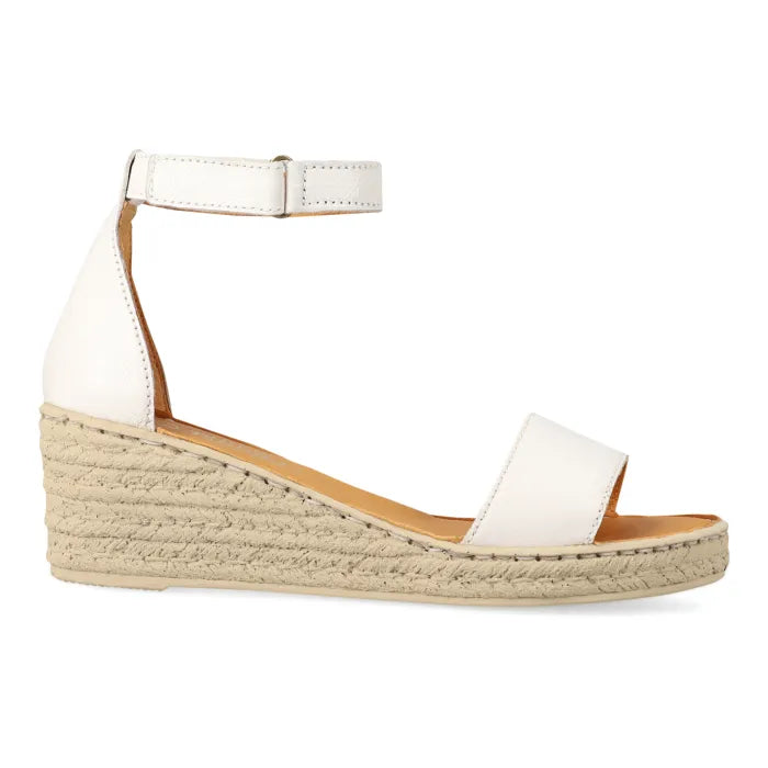 A white leather wedge sandal with an ankle strap and a espadrille-look platform wedge, shown from a side profile on a white background.