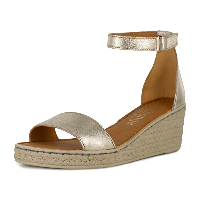 Gold wedge sandal on a white background