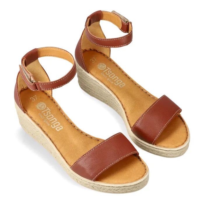 Brown sandals with espadrille print sole on a white background