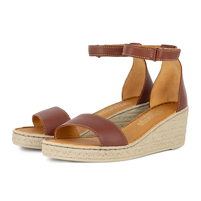 Brown wedge sandals with beige sole on a white background