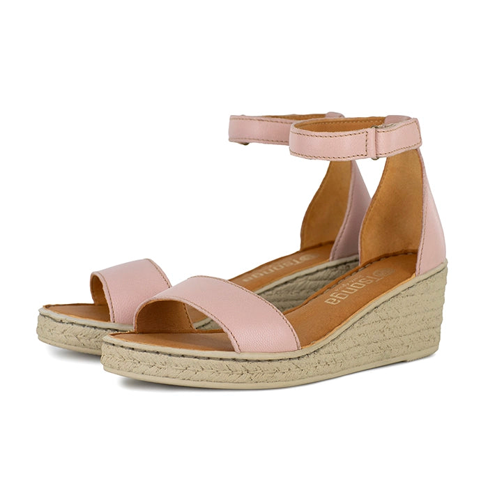 Pink wedge sandals with beige sole on a white background