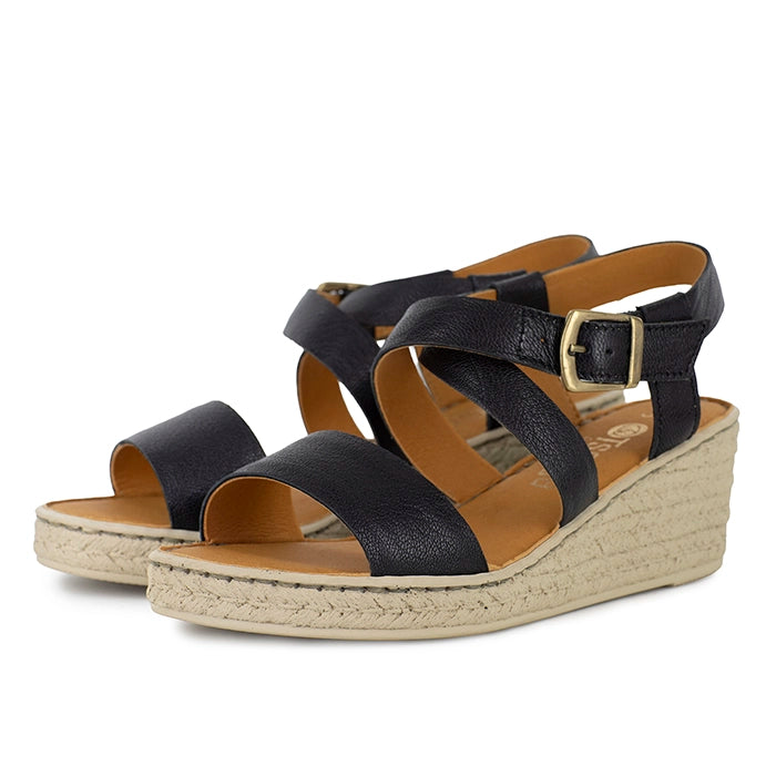 Black wedge sandals with beige sole on a white background