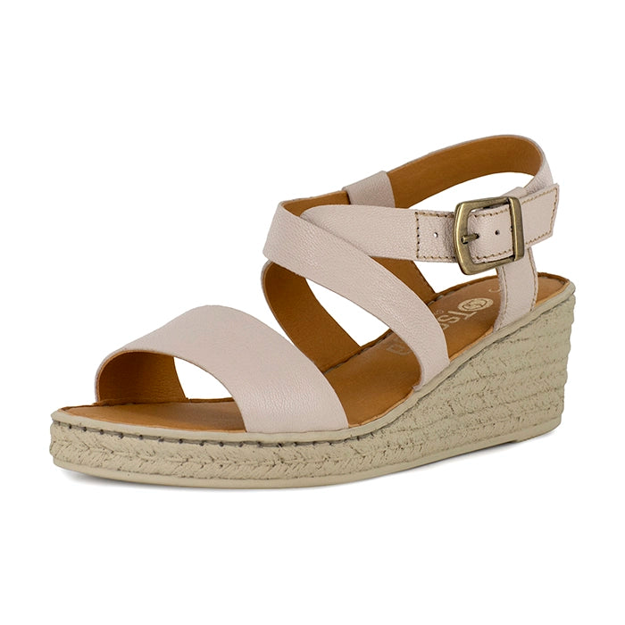 Beige wedge sandal with a strap and buckle on a white background