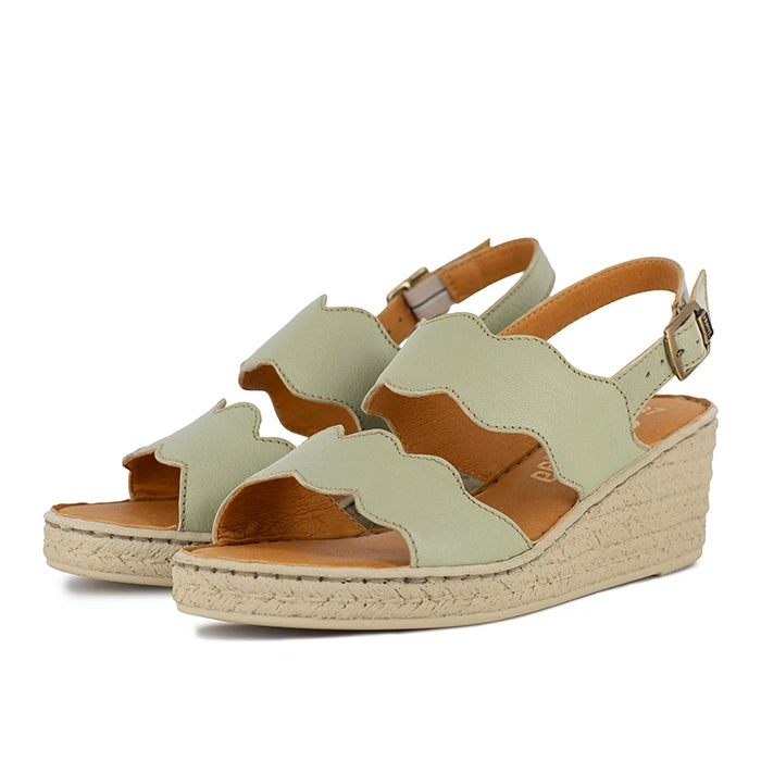 Pair of light green sandals on a white background