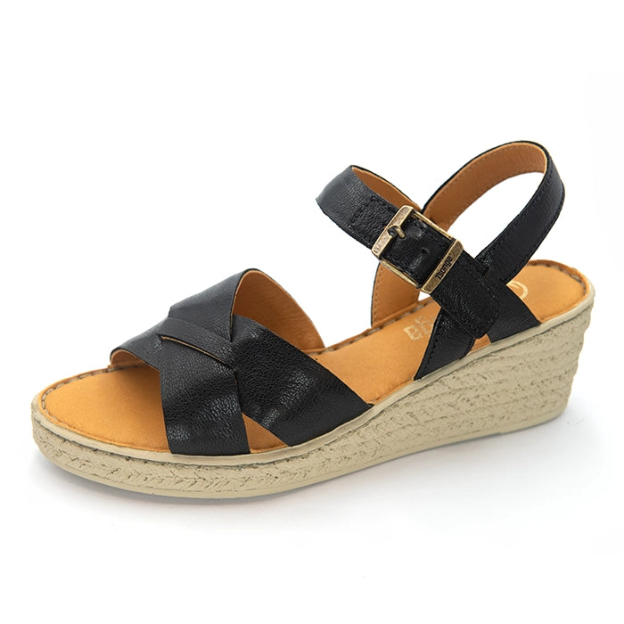 A single women's wedge sandal with black leather straps and a tan insole, shown on a white background.