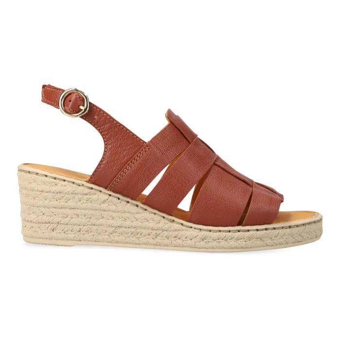 A women's wedge sandal with a terracotta brown leather upper, featuring crisscross straps, a slingback with a silver buckle, and a natural beige wedge sole.