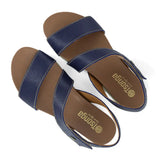 Pair of blue sandals with off white soles on a white background