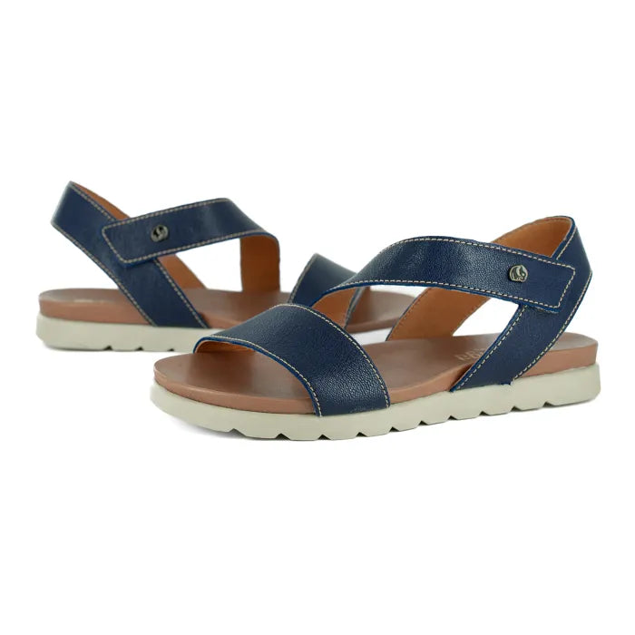 Pair of blue sandals with off white soles on a white background