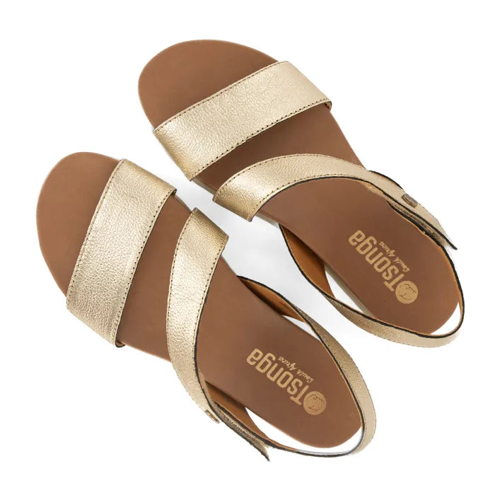 Gold sandals with off white soles on a white background