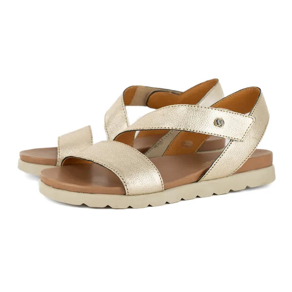 Gold sandals with off white soles on a white background