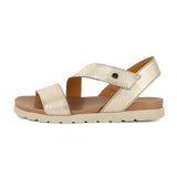 Gold sandal with a off white sole on a white background