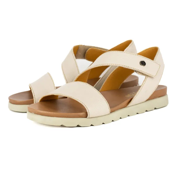 Beige sandals with off white soles on a white background