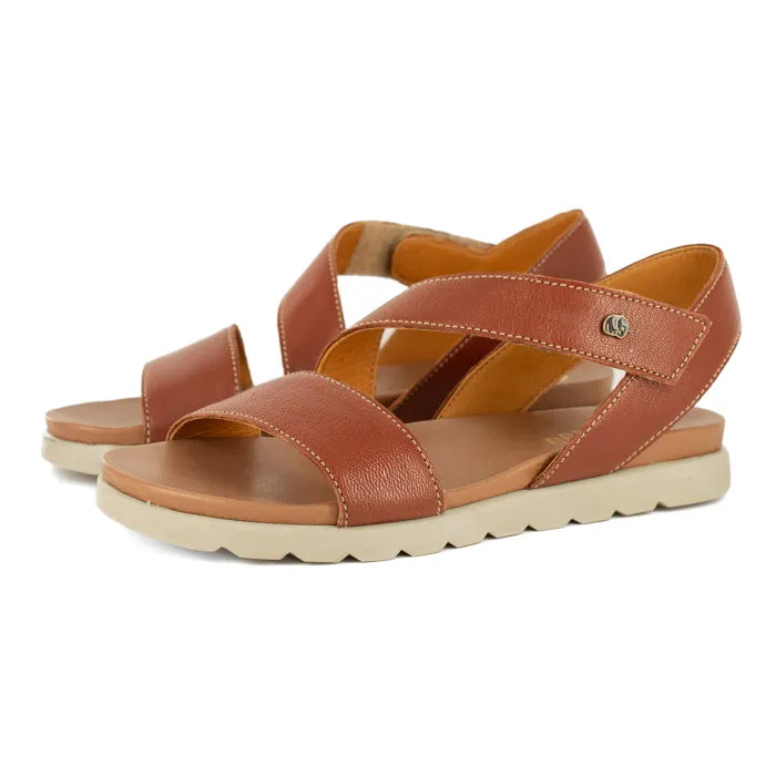 Pair of brown sandals with off white soles on a white background