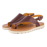Brown sandals with a white sole on a white background
