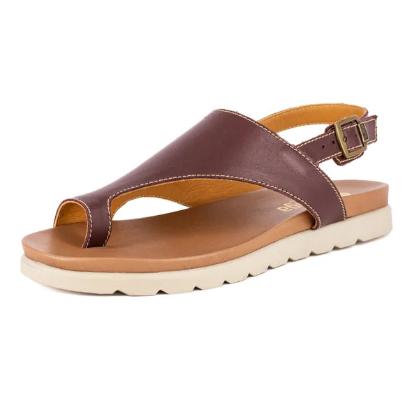 Brown sandal with a off white sole on a white background