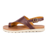 Brown sandal with a off white sole on a white background