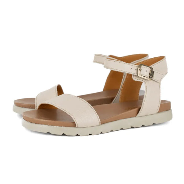 Beige sandals with a off white sole on a white background