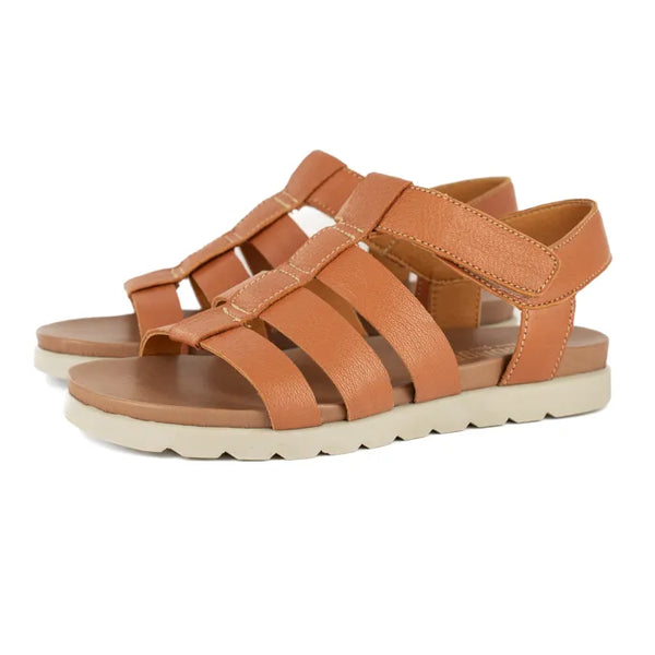 Pair of tan sandals with off white soles on a white background