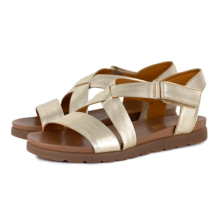 Gold sandals with tan soles on a white background