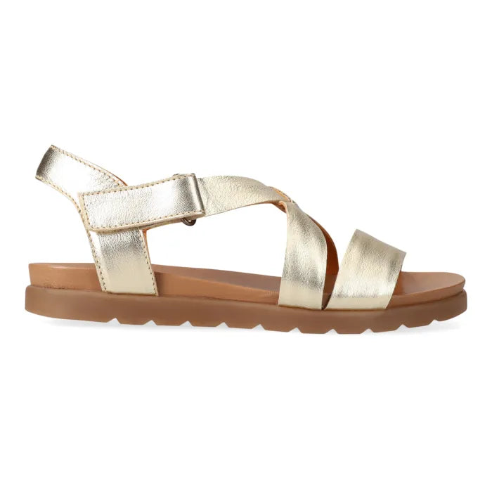 Gold sandal with a brown sole on a white background
