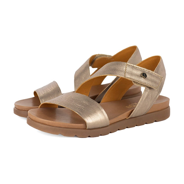 Pair of gold sandals with a white background