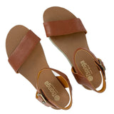 Pair of brown sandals with 'Tsonga' branding on a white background