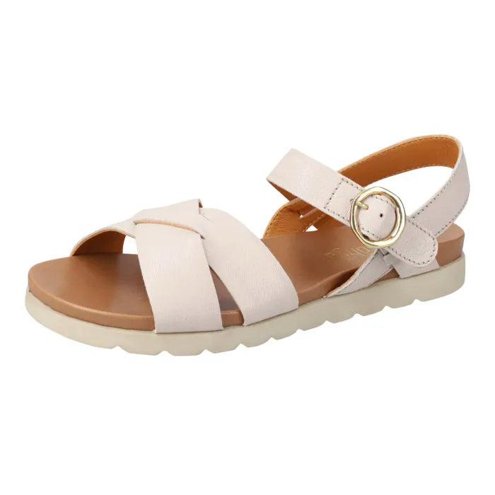 A single women's flat sandal in a cream colour, featuring criss-cross straps, an adjustable ankle strap with a gold-tone buckle, and a tan footbed, shown against a plain white background.