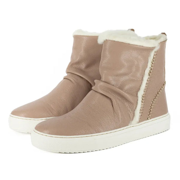 Pair of beige winter boots with white fur lining on a white background