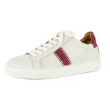 Cream sneaker with a maroon accent on a white background