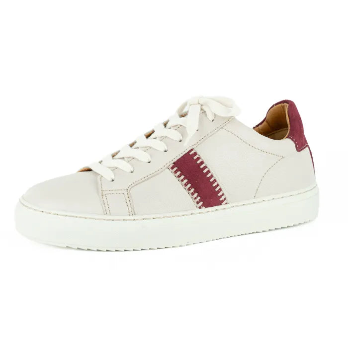 Cream sneaker with a maroon accent on a white background