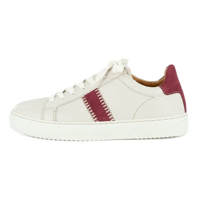 Cream sneaker with maroon accents on a white background