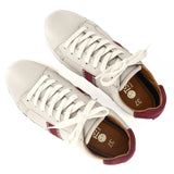 Pair of sneakers with white laces on a white background