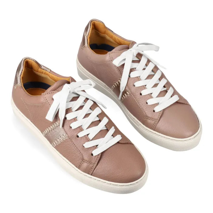Pair of beige sneakers with white laces on a white background