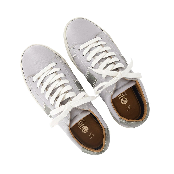 Pair of grey sneakers with white laces on a white background