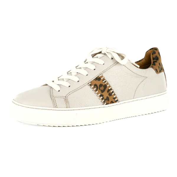 Cream sneaker with leopard print accents on a white background