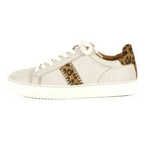 Cream sneaker with leopard print accents on a white background