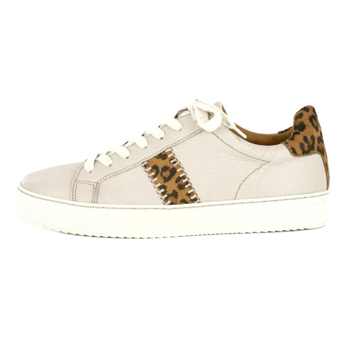 Cream sneaker with leopard print accents on a white background