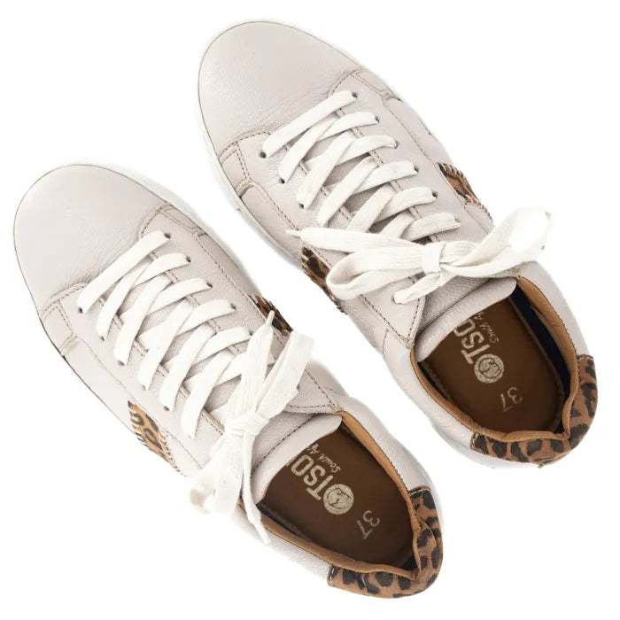 Cream sneakers with leopard print soles on a white background
