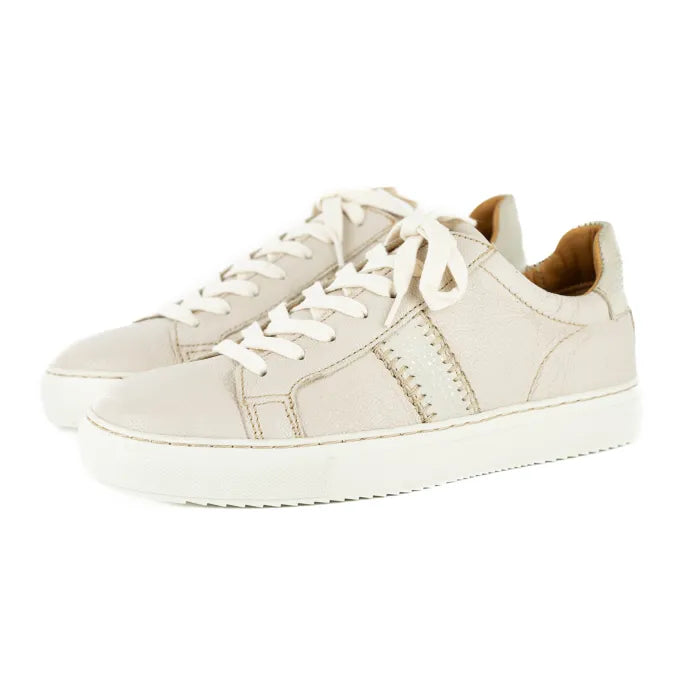 Pair of cream sneakers on a white background