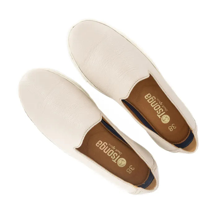 Pair of cream-colored loafers with brown insole on a white background