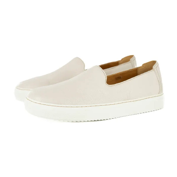 Pair of cream slip-on shoes on a white background