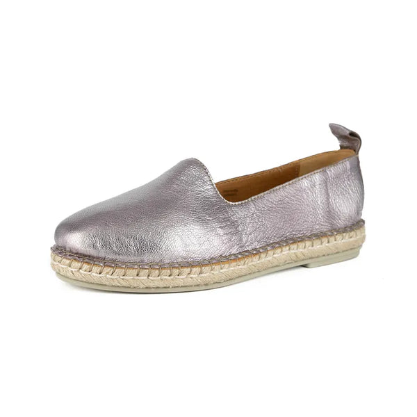 Pink metallic espadrille shoe on a white background