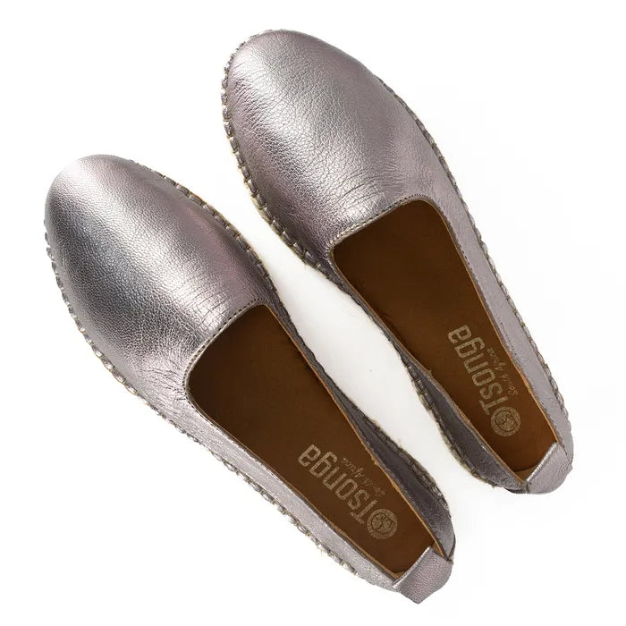 Pair of pink flat shoes with brown soles on a white background
