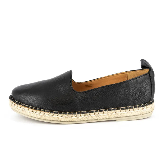 Black leather espadrille shoe with gold sole on a white background