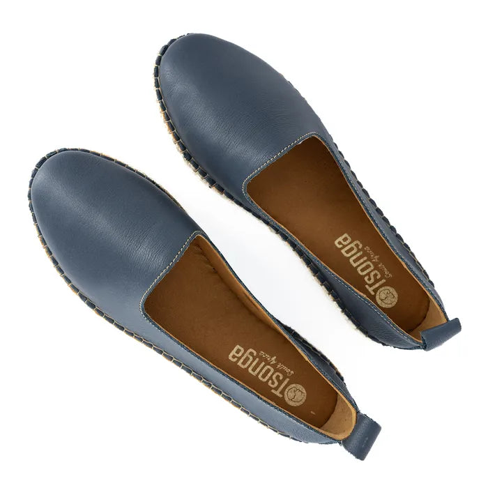 Pair of blue flat shoes with brown soles on a white background