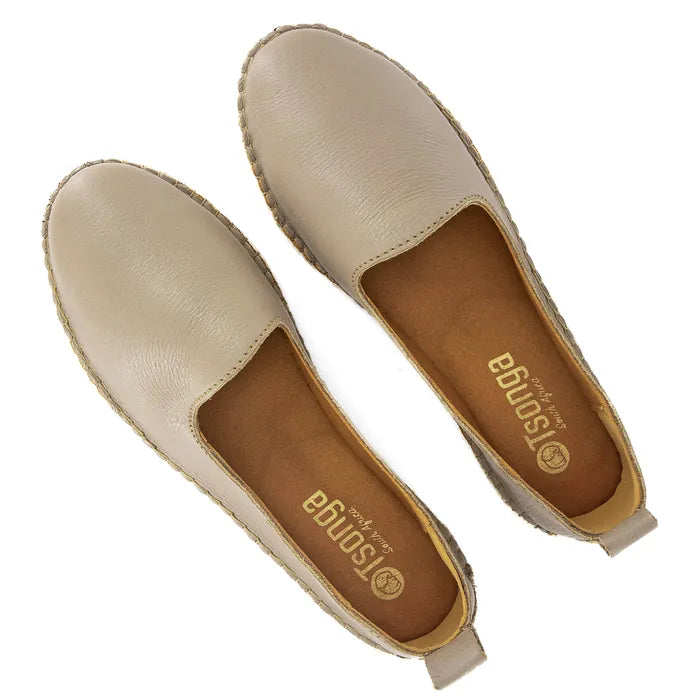 Pair of beige espadrilles with brown soles on a white background